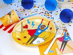 a party table set up with plates, napkins and decorations