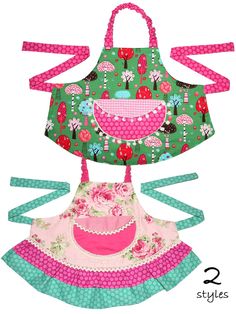 three aprons with pink and green designs on them