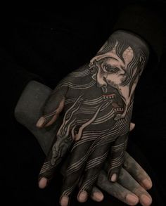 a person with tattoos on their hands and hand