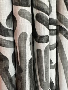 black and white curtains with abstract designs on them