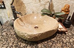 a stone sink sitting on top of a counter