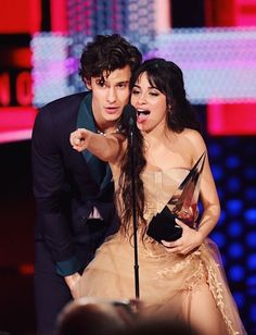 the young man and woman are posing with their award for best performance in a musical