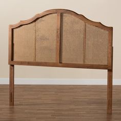 the headboard is made out of wood and has wicker panels on each side