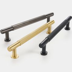 three different types of brass and black handles