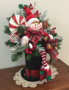 a christmas arrangement with a teddy bear and candy canes