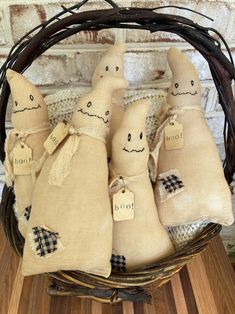 a basket filled with burlocked stuffed animals sitting on top of a wooden floor