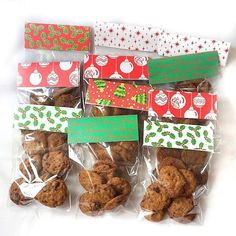 six bags of cookies wrapped in plastic and decorated with christmas decorations on white background,