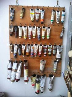 a wall mounted spice rack filled with lots of spices