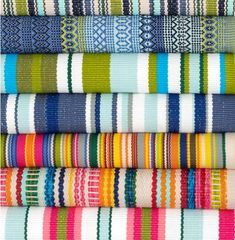 a stack of colorful striped fabrics