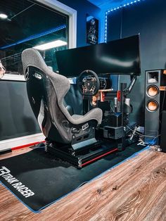 a computer desk with speakers and a gaming chair