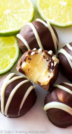 chocolate covered lemons and lime slices on a plate