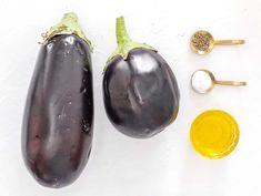 an eggplant, mustard and other ingredients on a white surface