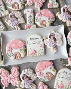 decorated cookies are on a plate with the name charm's written in white and pink