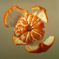 an orange cut in half sitting on top of a table