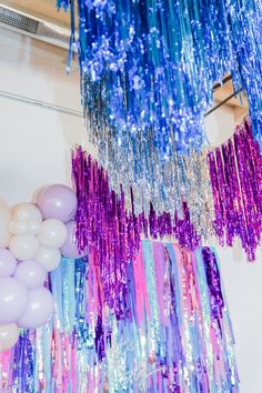 Make your event sparkle with fringe tinsel aerials in bright pink, purple, and turquoise! This colorful, glam setup is perfect for a mom’s wild night or sweet 16 bash. Ideal for planners and hosts wanting a fun, bold look. Discover decor ideas to add flair and excitement to your party atmosphere! Wild Night