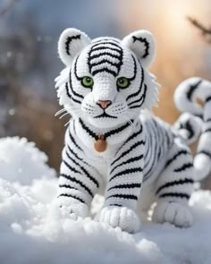 there is a small white tiger toy in the snow