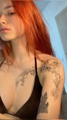 a woman with red hair and tattoos on her chest