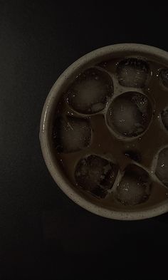 a bowl filled with ice and water on top of a table