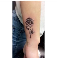 a woman's arm with a rose tattoo on it