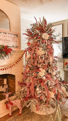 a decorated christmas tree in a living room with red and white ribbons on the top