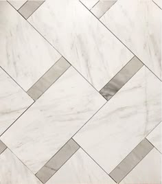 a white marble floor with grey and silver lines on the tile in this photo is an interesting pattern