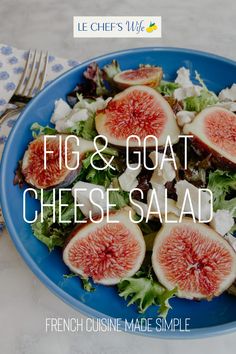 a blue plate with figs and goat cheese salad on it next to a fork