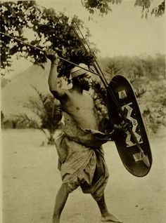 an old photo of a man carrying a shield