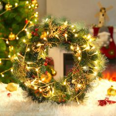 a christmas wreath sitting on top of a white fur covered floor next to a fire place