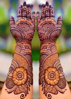 two hands with hendi tattoos on them and the words ar mehndi art