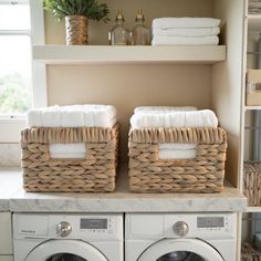 two wicker baskets on top of a washer and dryer