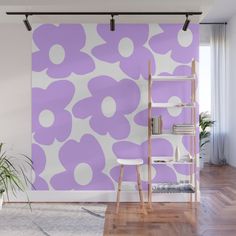 a purple and white flowered wall mural in a living room