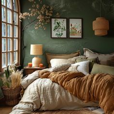 a bedroom with green walls and brown bedding