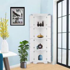 a room with blue walls and white shelves filled with vases, plants and pictures