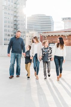 a family walking in the city holding hands