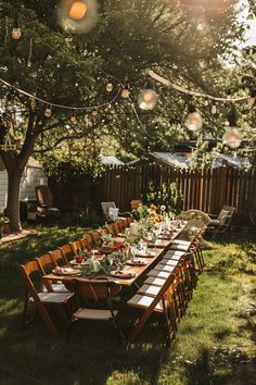 an outdoor dinner table set up with plates and utensils for guests to eat