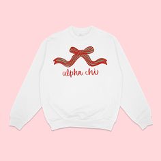 a white sweatshirt with red ribbon on the chest and words above it that says, alpeno chi