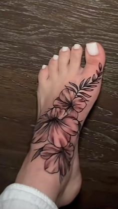 a woman's foot with a flower tattoo on it