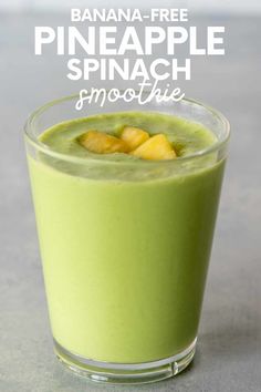 a green smoothie in a glass with pineapples on top and text overlay that reads, banana - free pineapple spinach smoothie smoothie