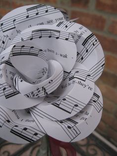 a paper flower made out of sheet music