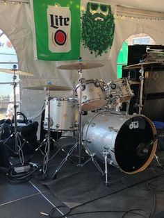 a drum set sitting on top of a stage next to a sign that says lite