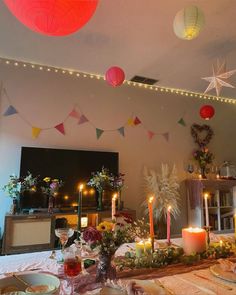 a table is set with candles, plates and other decorations for a party or celebration