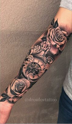 a man's arm with roses and an old pocket watch tattoo on the forearm