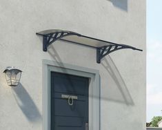 an image of a door and lamp on the side of a building