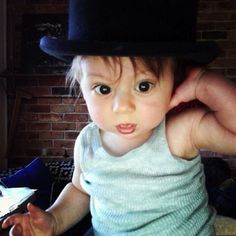 a small child wearing a top hat on his head