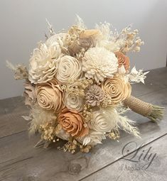 the bridal bouquet is made up of flowers and feathers