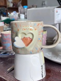 there is a coffee cup with a heart on it