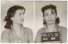 an old photo of two women in prison mugs, one holding a sign that says florida state police