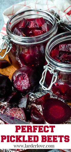 jars filled with pickled beets sitting on top of a wooden cutting board