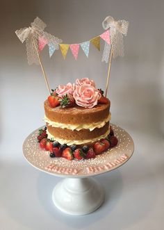 a cake with strawberries and flowers on top