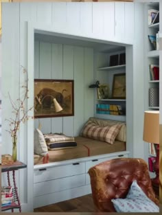 a room with some bookshelves and a chair in it